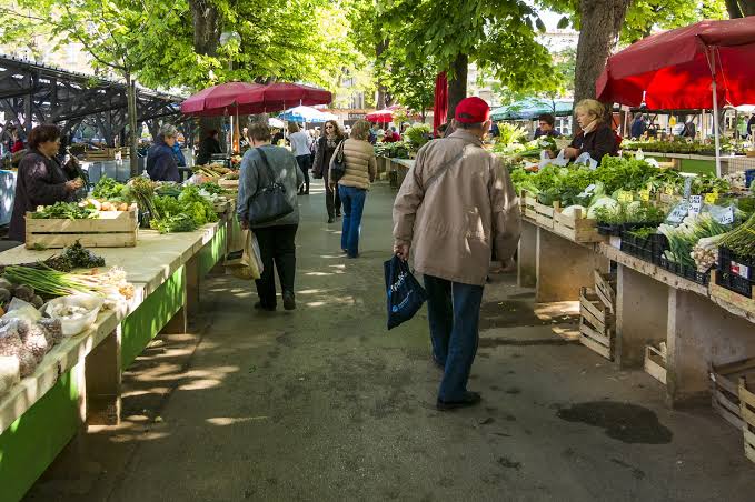Local market stalls set up in a hill town street