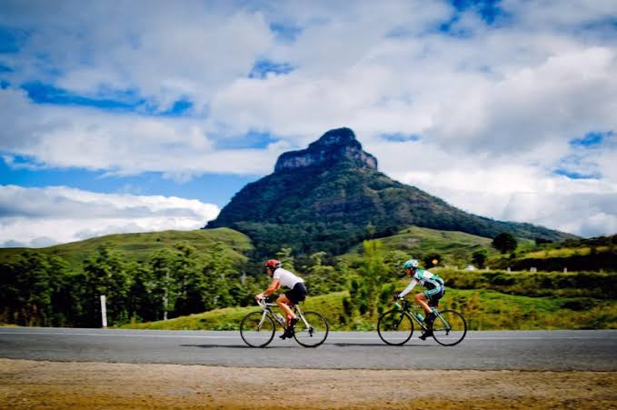 Cyclist on a quiet country road through hill country