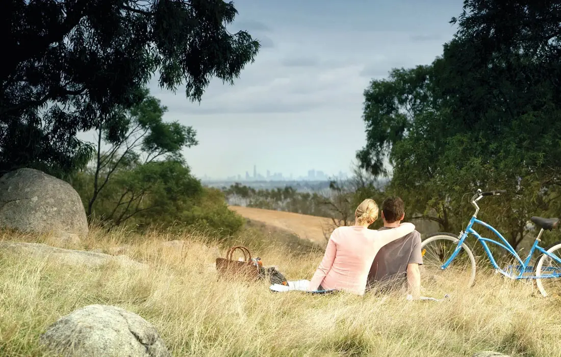Picnic blanket set out on a hillside with a view